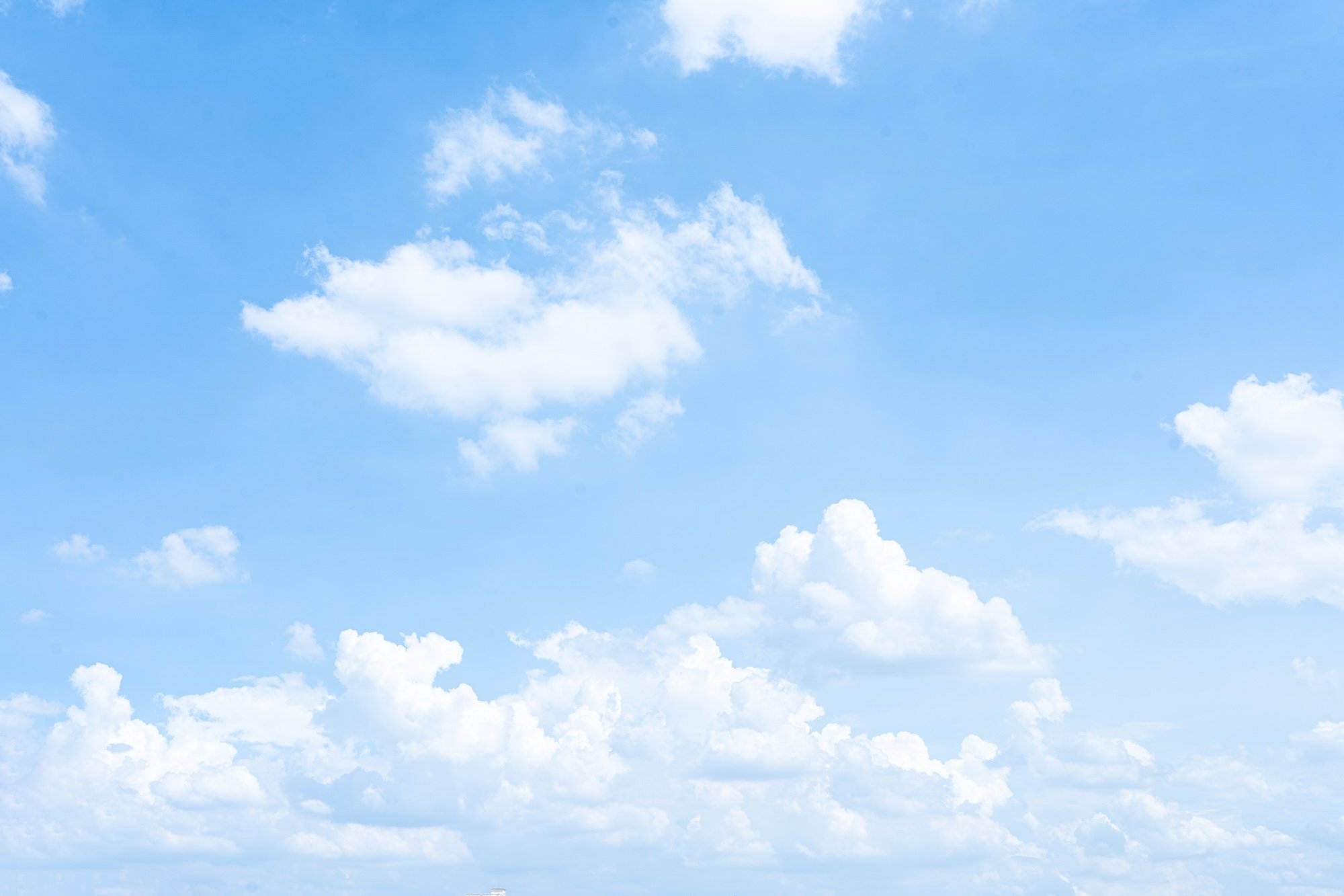 Sky with fluffy white clouds.