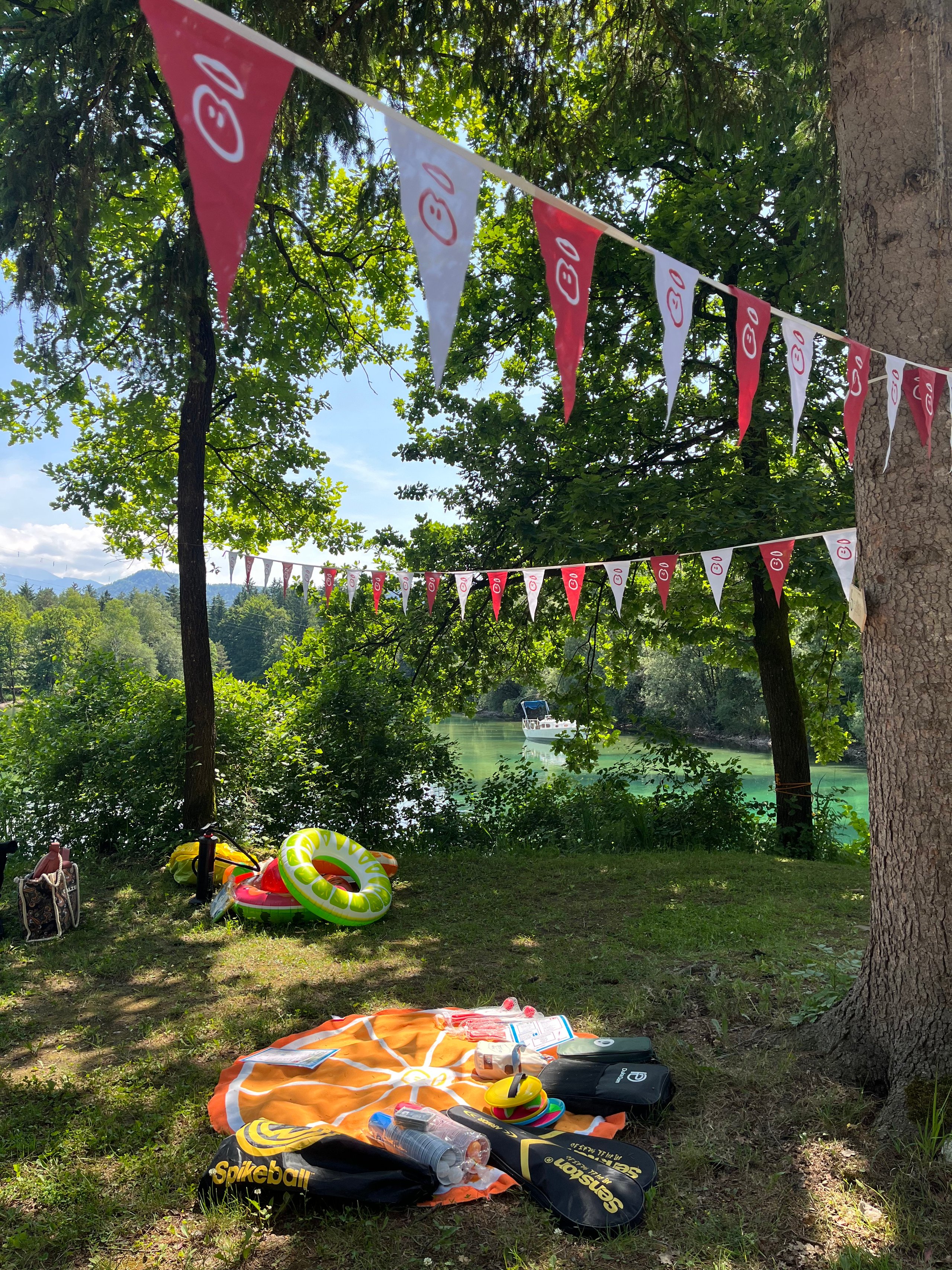 Picnic setup with decorations, near a river.