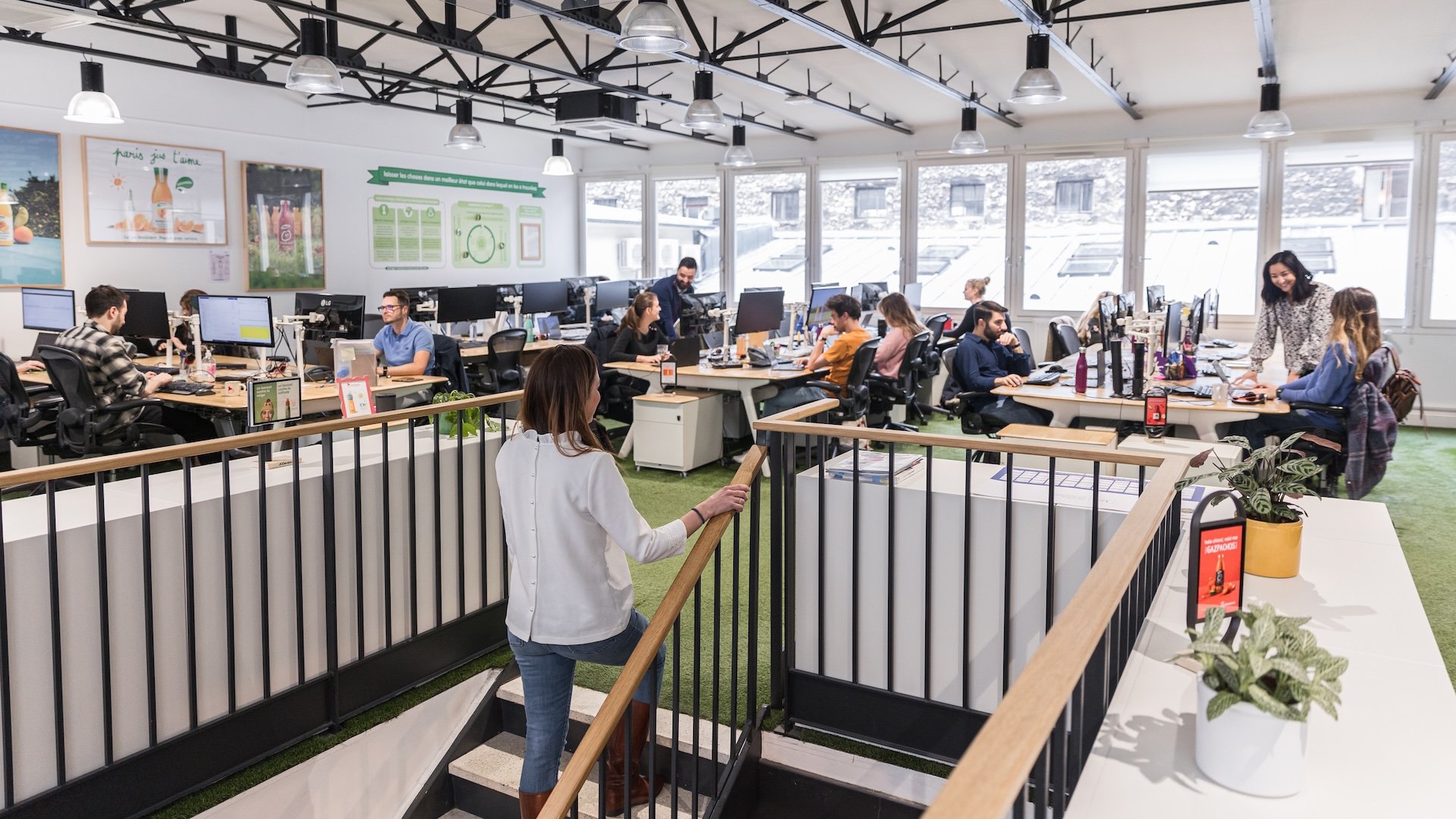 People working at desks in a modern office space.