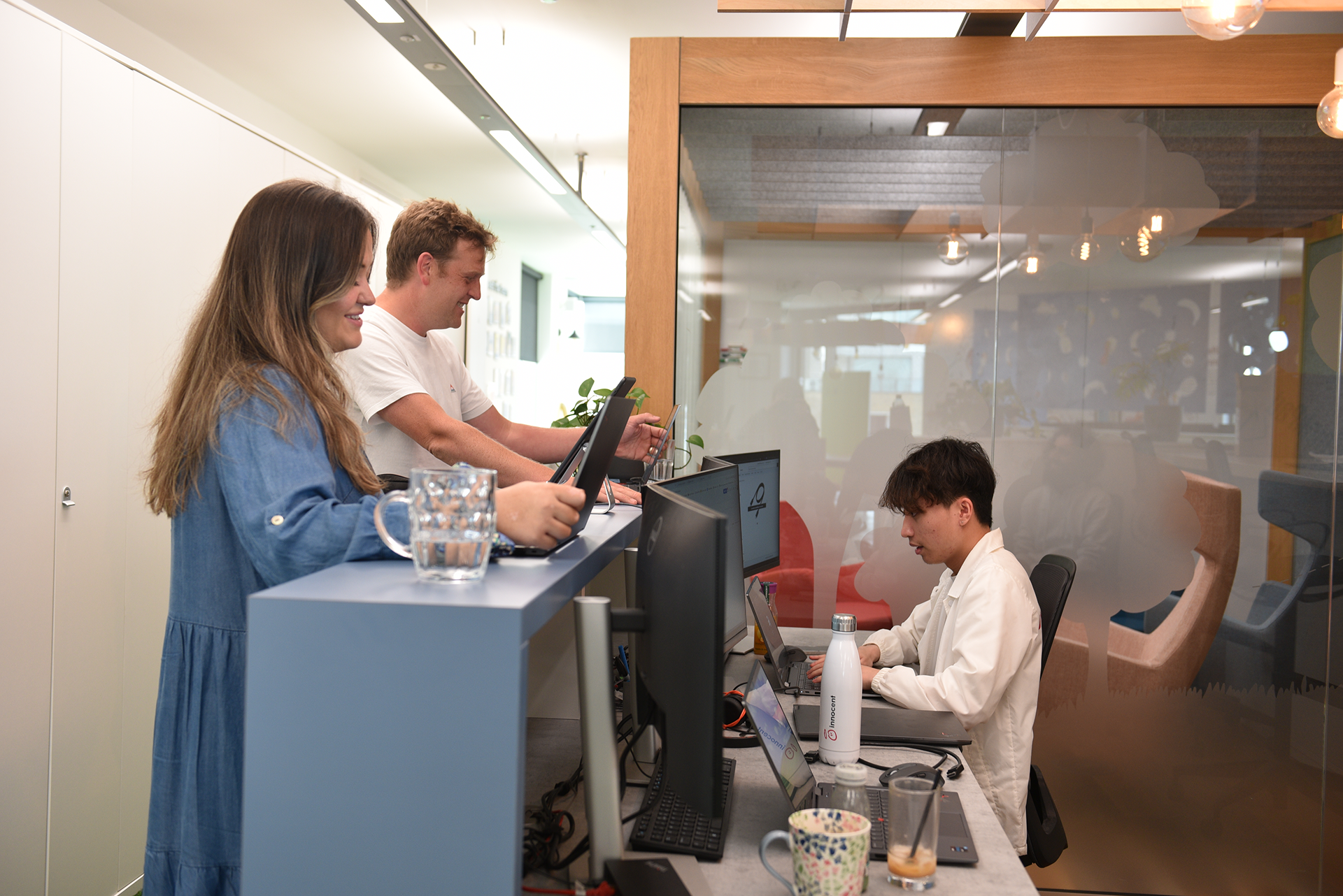 People working on computers in an office setting.