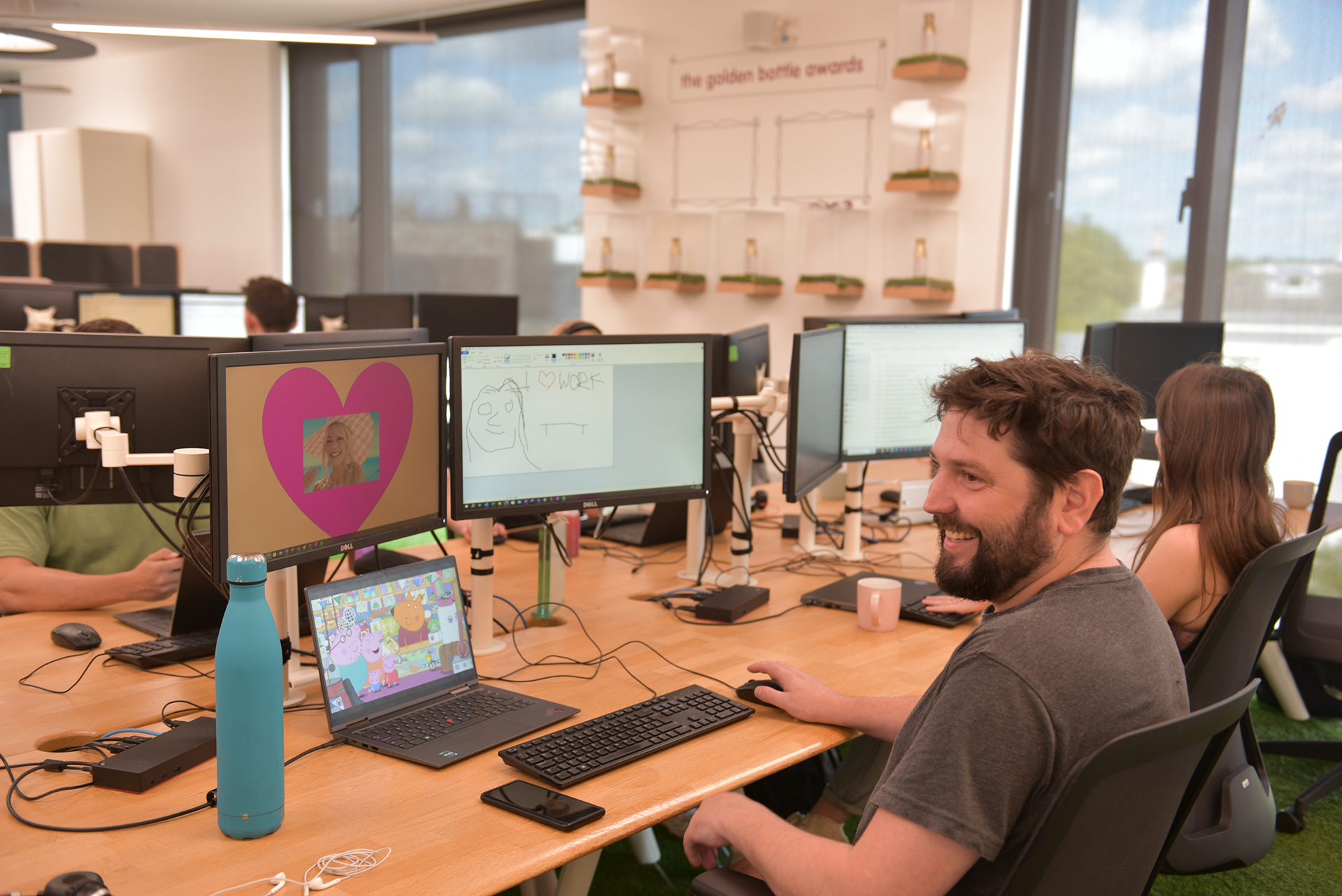 People working at desks with computers.